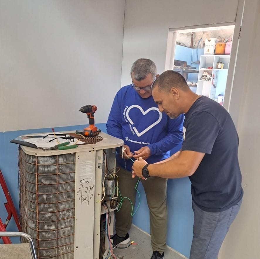 Estudiantes del Instituto Tecnológico Americano realizando prácticas del curso de aire acondicionado con un equipo de climatización.